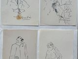 several drawings of people are displayed on a refrigerator door