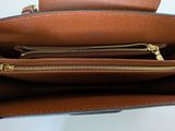 the inside of a brown purse with a zipper on it