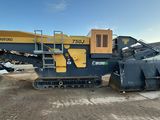 a large machine that is sitting in the dirt