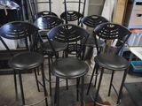 six black stools sitting in a circle on the floor