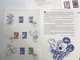 a picture of a book with stamps and a picture of mickey mouse