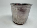 a silver cup that is sitting on a table