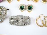 several pieces of jewelry including a broochle, earrings, and a ring