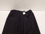 a pair of black pants sitting on top of a white table