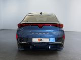 the rear end of a blue car in a room with a white wall