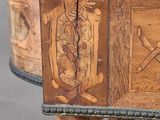 a wooden table with carvings on the top of it