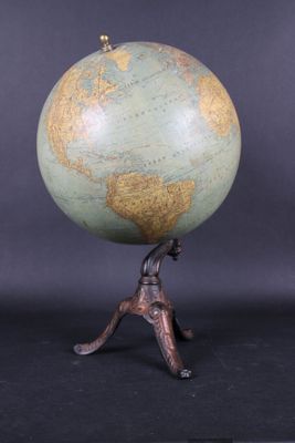 an image of a small globe on a stand with a man holding it