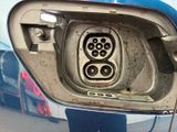 a close up of a car ' s door handle with a power cord attached to it