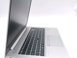a silver laptop computer sitting on top of a white table