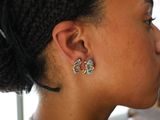 a woman that has a pair of earrings on her ear