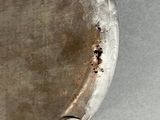 a silver plate with a hole in the middle of it