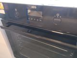 a black oven with the door open in a kitchen
