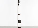 a tall metal pole with a clock on top of it