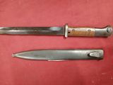 two knives are sitting on a red surface next to each other