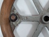 a close up of a metal wheel on a wall