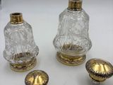 three pieces of glass and brass on a white surface