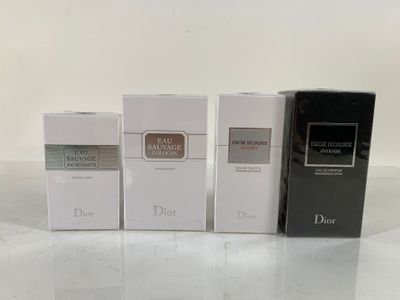 three boxes of perfume sitting on top of a white table