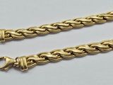 a pair of gold chain bracelets on a white background