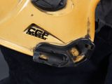 a close up of a person wearing a yellow helmet and black pants
