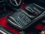 the interior of a red car with black leather seats and a steering wheel