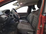 the interior of a red car with a steering wheel and dashboard