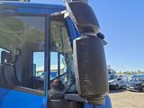 a blue truck that is parked in a lot