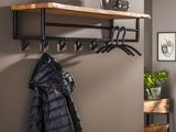 a coat rack with a coat hanging on it in a room