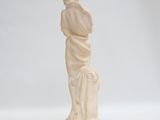 statue of a woman holding a child on a white background