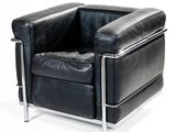 black leather chair with chrome legs and arm rests against a white background