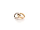 a close up of a gold and silver ring on a white surface
