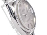 a watch that is sitting on a silver bracelet