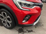 a close up of the front end of a red car
