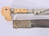 two different types of knives on a white surface