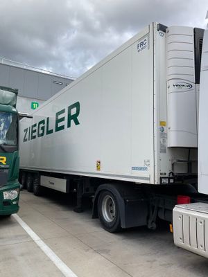 two large trucks parked next to each other in a parking lot