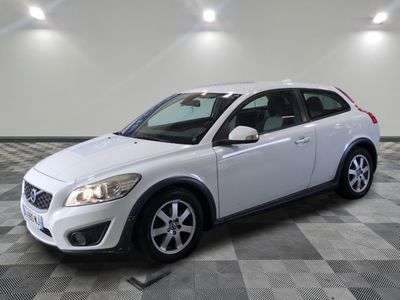 the white volvo c - cross is parked on a checkered floor