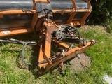 an image of a tractor plow sitting in the grass