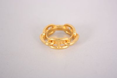 a close up of a gold ring on a white surface