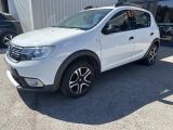 a white dacia parked in front of a building in a parking lot
