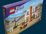 a box of lego friends set with a horse and buggy in it
