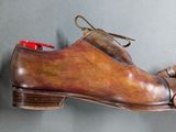 a pair of shoes hanging on a wall with a shoelacer