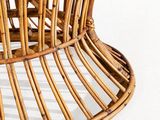 a wicker chair that is sitting on a white surface