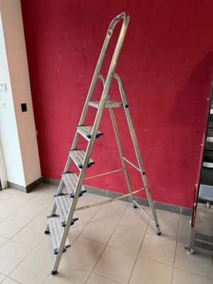 a ladder that is leaning against a wall in a room