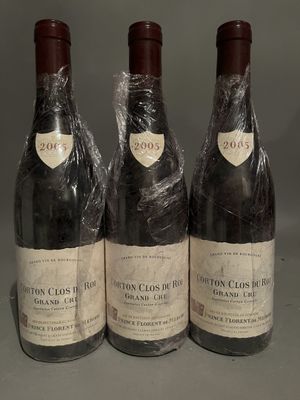 three bottles of wine wrapped in plastic sitting on a table
