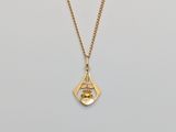 a gold plated necklace with a small diamond and a gold chain