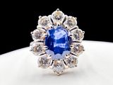 an image of a blue sapphire and diamond ring on a white plate