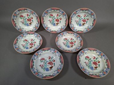 six small plates with floral designs on them on a table
