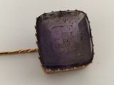 an image of a close up of a piece of jewelry on a white surface