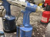 two air tools that are sitting on a table
