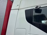 a white semi truck with a red trailer attached to it ' s side