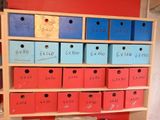 many boxes on a shelf with numbers on them